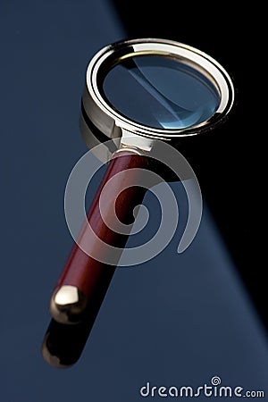 Magnifying glass on black table Stock Photo
