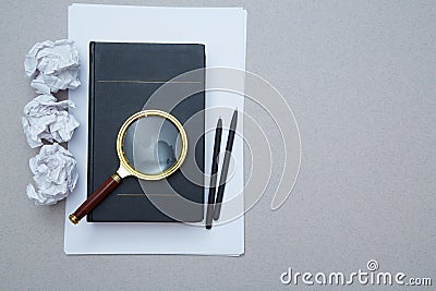 Magnifying glass, book and crumpled paper. FAQ, Q and A and SEO. Question, answer or analysis. Mockup, copy space Stock Photo