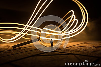 Magnifying glass in dark blue background, under the light, mysterious detective concept Stock Photo