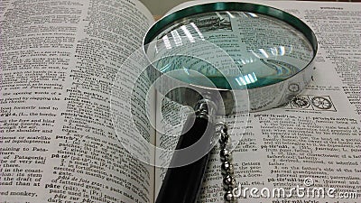 Magnifying glass and encyclopedia Stock Photo