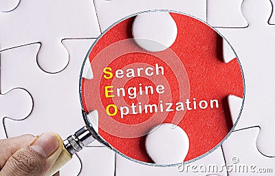 Magnifying glass focusing on SEO Stock Photo