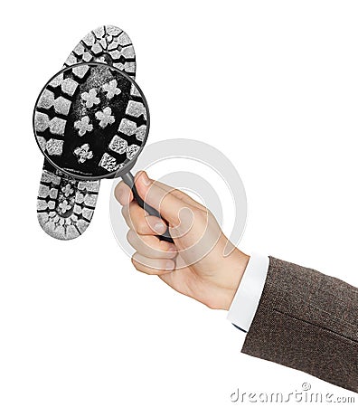Magnifying glass in hand and shoe printout Stock Photo