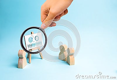 Magnifying glass is looking at the businessman reports to his staff at a briefing, a discussion of the business strategy, Stock Photo
