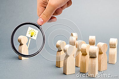 Magnifying glass is looking at a man with a poster with a picture of the bulb Stock Photo