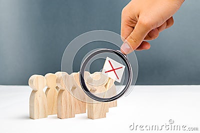 Magnifying glass is looking at the people on protest movement. An angry mob of wooden figures of people with a poster. Social Stock Photo