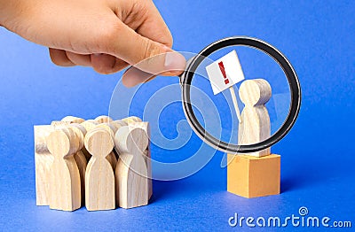 A magnifying glass looks at a person with a poster exclamation mark is on the box and draws the publics attention to the problem Stock Photo