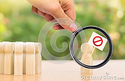 A magnifying glass looks at a person with a poster protests and draws public attention to the problem. Social discontent Stock Photo