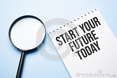 Magnifying glass loupe with sign start your future today blue table Stock Photo