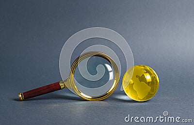 Magnifying glass and planet earth glass ball. Concept of global search and globalization process. International business Stock Photo