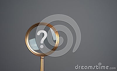 Magnifying glass and question mark. Curiosity, inquiry, uncertainty. Stock Photo