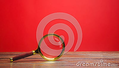Magnifying glass on a red background. Search and analysis, analytics and study. Pay attention to details and problems. Find Stock Photo