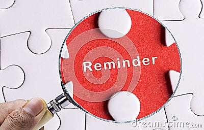 Magnifying glass searching missing puzzle peace reminder Stock Photo