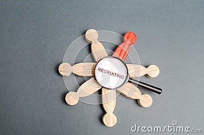 Magnifying glass with the word Recruiting and a team of people. Recruiter services. Hiring. Hire. Hr. Workforce search concept. Stock Photo