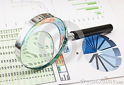 Magnifying glass and the working paper Stock Photo