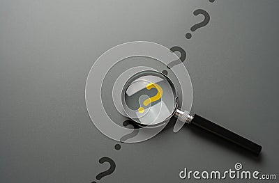 Magnifying glass and yellow question mark. FAQ. Stock Photo