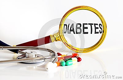 Magnifying lens with text DIABETES with medical tools Stock Photo