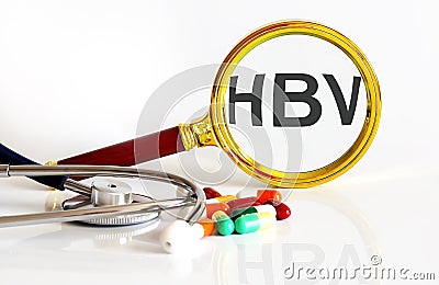 Magnifying lens with text HBV with medical tools Stock Photo