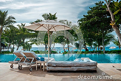Mahe Seychelles , luxury swimming pool with chairs at the Four Season resort in the mountains La Digue tropical Island Stock Photo