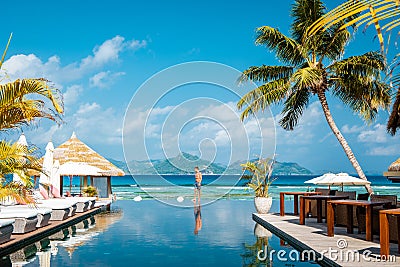 Mahe Seychelles , luxury swimming pool with chairs at the Four Season resort in the mountains La Digue tropical Island Stock Photo