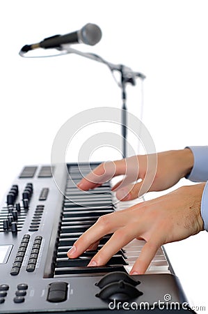Maicrophone and male hands playing the piano Stock Photo