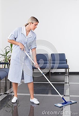 Maid Cleaning The Floor Stock Photo