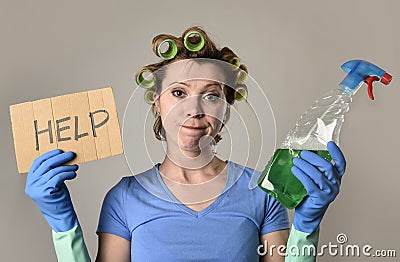 Maid cleaning woman or lazy housewife in stress in rollers with spray bottle asking for help Stock Photo