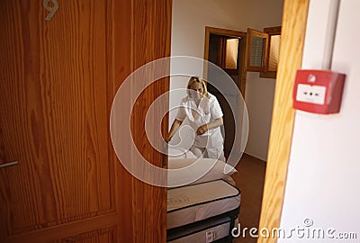 Hotel maid working in a hotel room in mallorca Editorial Stock Photo