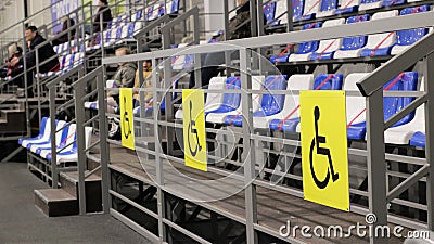 Seats for disabled people in empty sports stands Editorial Stock Photo