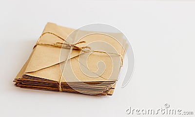 Kraft envelopes lie on a light background tied with twine. Stock Photo