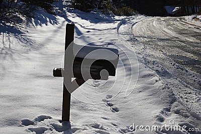 Mailbox on Ice covered road after snowstorm Stock Photo