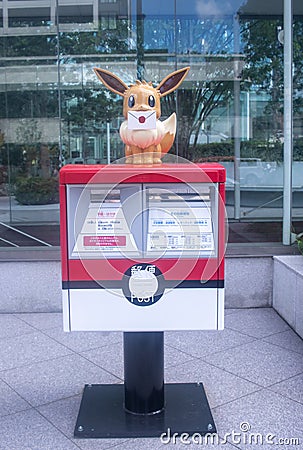 Mailbox of the Japanese Post with a statue of the character Eevee Editorial Stock Photo