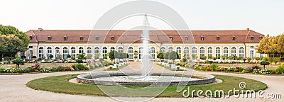 The main building of the Orangery and the fountain in the Central Park of Ansbach Stock Photo