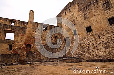 The main courtyard of the castle surrounded by ruins of buildings and castle walls. Landstejn Castle Stock Photo