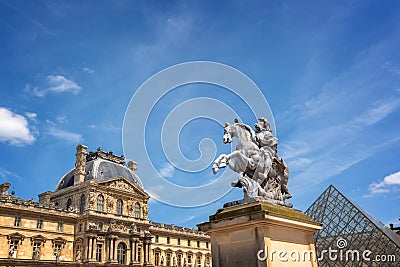 Main courtyard of the palace of the Louvre palace with an equestrian statue of king Louis XIV in Paris France Editorial Stock Photo