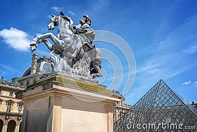 Main courtyard of the palace of the Louvre palace with an equestrian statue of king Louis XIV in Paris France Editorial Stock Photo