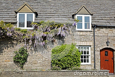 The main facade of a medieval house with brickstone and flagstone roof in Corfe Castle village, Isle of Purbeck, Dorset Editorial Stock Photo