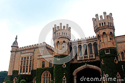 Main gate with battlement towers of bangalore palace with creeper plant. Stock Photo