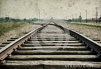 Main gate and railroad to nazi concentration camp of Auschwitz Birkenau. Effect with grunge background, fake old photo Editorial Stock Photo