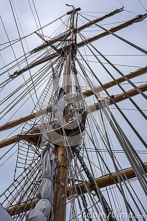 Main mast, crow's nest, sails, yards and rigging ropes on the deck of US coastguard tallship Eagle. Stock Photo