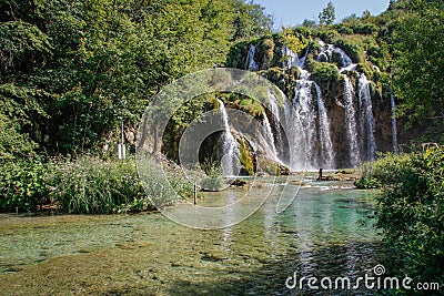 The main natural landmark of Croatia is the Plitvice Lakes with cascades of waterfalls. Emerald clear cold water on the background Stock Photo