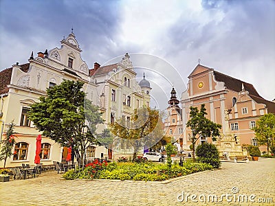 The main square with old buildings and Parish Church in the charming little town of Frohnleiten in the district of Graz-Umgebung, Stock Photo