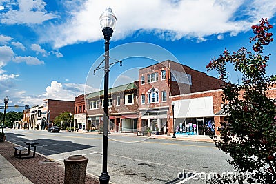 Main street of an old American city with a typical brick building. Tourist area, restored cinemas and shops Editorial Stock Photo