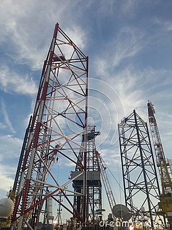 Main structure of Jackup Drilling Rig. There are 3 cranes, 3 jackup leg upper section and 1 drilling mast. Editorial Stock Photo