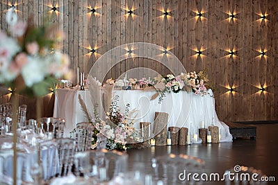 Main table at a wedding reception with beautiful fresh flowers. Wedding day. Stock Photo