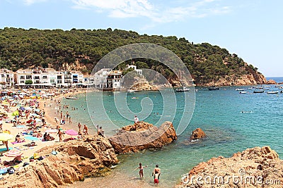 Main view of crowdy beach of Tamariu with village in background, Costa Brava, Catalonia, Spain Editorial Stock Photo