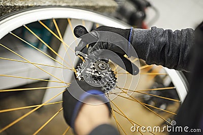 Maintenance of a bicycle: person disassembling sprocket set of a bike wheel Stock Photo