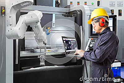 Maintenance engineer use laptop computer control automatic robot Stock Photo