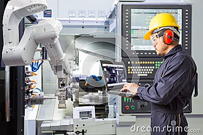 Maintenance engineer using laptop computer control automatic rob Stock Photo