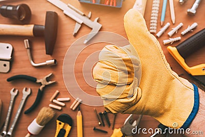 Maintenance handyman gesturing thumb up approval hand sign, top Stock Photo