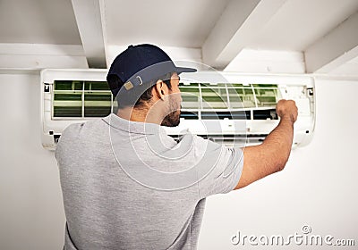 Maintenance service, air conditioner technician and man, working on ventilation filter or ac repair. Contractor Stock Photo